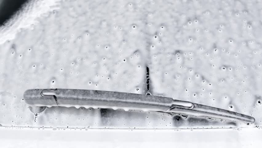 Car wash service with self-service option, foam sliding down the glass