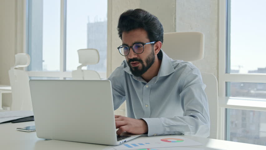Upset frustrated Arabian muslim guy businessman male worker employee manager stressed Indian business man looking at laptop pc at office stress problem with computer fail loss bankrupt failure trouble Royalty-Free Stock Footage #3412479045