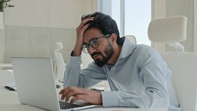 Upset frustrated Arabian muslim guy businessman male worker employee manager stressed Indian business man looking at laptop pc at office stress problem with computer fail loss bankrupt failure trouble - Powered by Shutterstock - Get 15% off with code: PIKWIZARD15