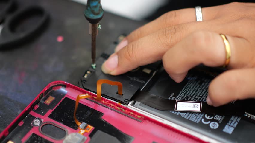 Close-up shot showing the process of cell phone repairing. Technician repairing the phone. Fixing smartphone and upgrade mobile details. Disassembled cell phone. Internal components of a smartphone. Royalty-Free Stock Footage #3412506859