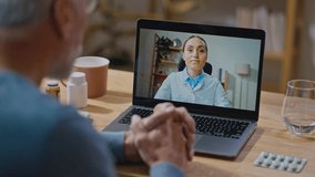 From above elderly male making laptop video call to medical practitioner and speaking while sitting at table at home. Healthcare concept - Powered by Shutterstock - Get 15% off with code: PIKWIZARD15