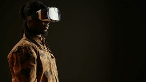 African american man using virtual reality headset with 3d interactive vision and metaverse simulation, artificial intelligence. Young person having fun with modern vr glasses in studio. - Powered by Shutterstock - Get 15% off with code: PIKWIZARD15