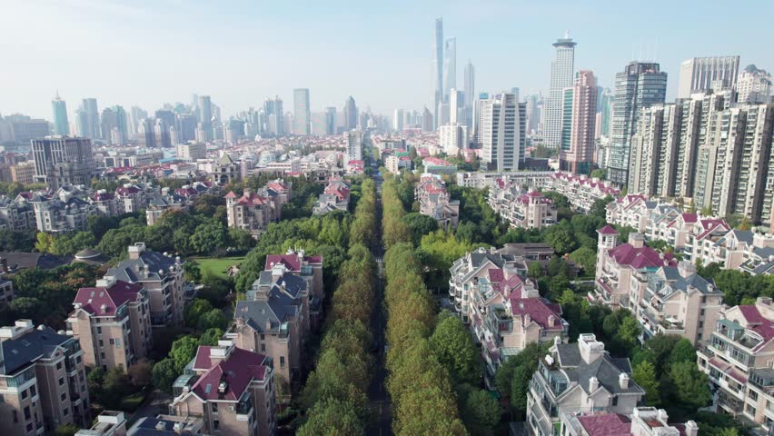 Drone aerial footage of residential house in the Lujiazui community of Pudong, Shanghai, China. Green trees and villas, the most valuable houses in Shanghai city, 4k real time footage high angle view.