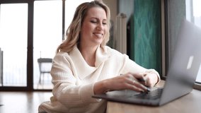 Mid adult woman working from home online