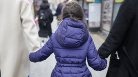 Slow-motion video of a Korean family's children and parents walking in the streets of Seoul, South Korea