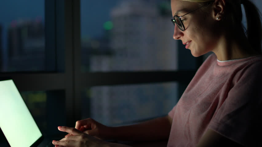 Young female student in eyeglasses making research online preparing coursework at night,  freelancer typing on laptop with copy space for advertising on screen hurring for deadline Royalty-Free Stock Footage #34126696