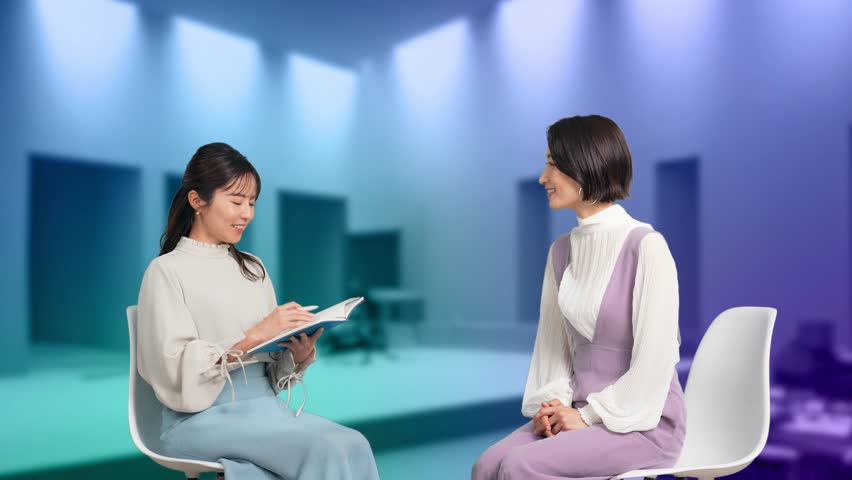 Two Asian women interviewed with CG image in the background. Royalty-Free Stock Footage #3412739065