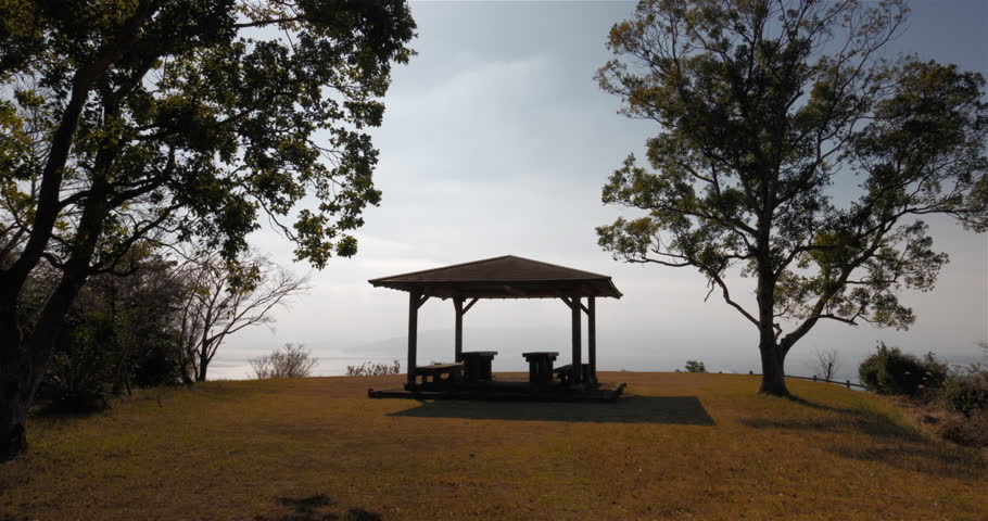 A pavilion in a park on top of a mountain.