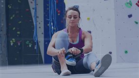 Animation of data processing over caucasian woman climbing wall. Global sports, science, computing, digital interface and data processing concept digitally generated video.
