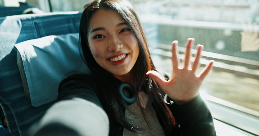 Happy asian woman, video call and train with peace sign for social media, travel or memory in public transport. Portrait of female person, face or smile while waving hand for hello on railway line Royalty-Free Stock Footage #3412777207