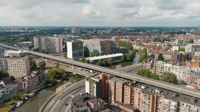 Ghent, Belgium. Esco (Scheldt) river embankment. Panorama of the city from the air. Cloudy weather, summer day, Aerial View, Departure of the camera