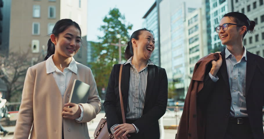 Walking, conversation and face of colleagues in the city talking for communication or bonding. Smile, discussion and portrait of professional Asian business people speaking commuting in urban own.