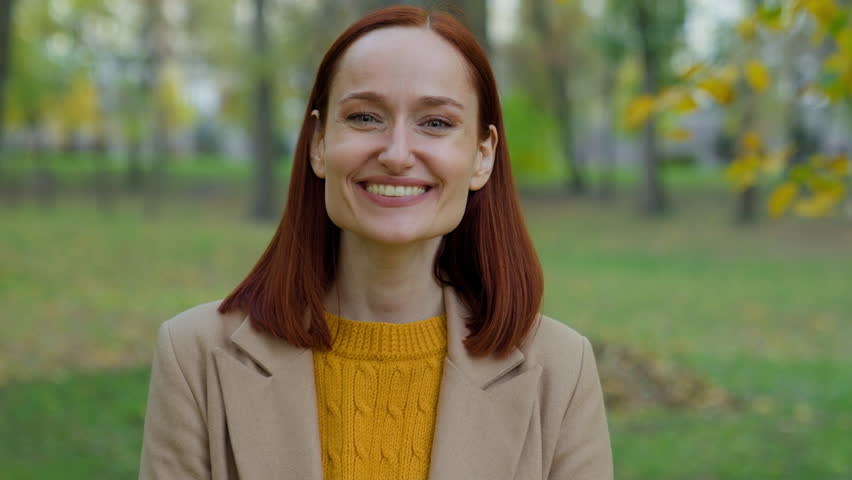 Portrait happy smiling laughing positive carefree cheerful glad woman Caucasian girl lady female in autumn park laugh smile looking at camera fun good mood satisfied toothy healthcare health dental