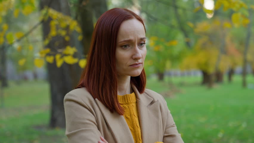 Pensive sad upset negative emotion thinking Caucasian woman girl female lady think pondering problem solution stress autumn park outside depression seasonal bad mood trouble date cancel frustrated