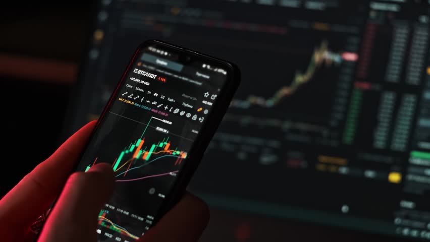 Investor checking crypto market on mobile phone app. Trader analyzing BTC price on cryptocurrency graph on smartphone screen. Businessmen analyze financial data use crypto exchange mobile application