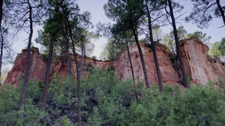 Ocher rocks for making paints for painters between some trees at sunset Royalty-Free Stock Footage #3413101465
