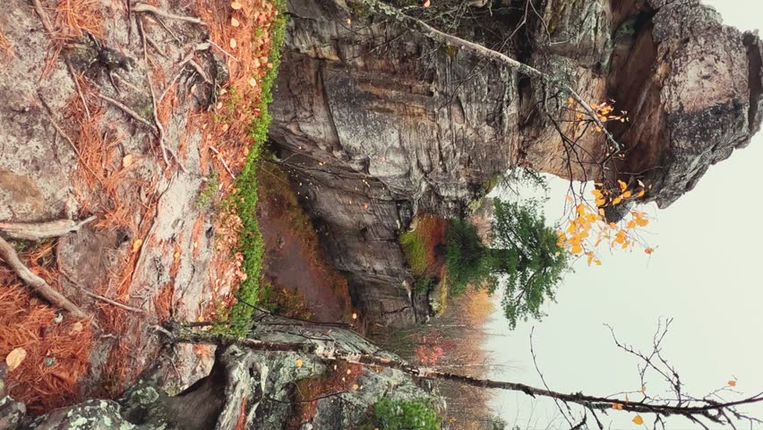 Stone City in autumn. Bright foliage and autumn landscape. The natural landscape is a rock formation in Central Russia, the Urals. A natural monument. Ancient rocky folding in the Ural Mountains. 4K