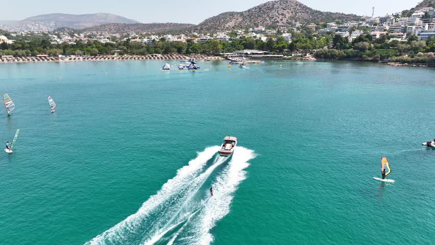 Aerial drone video from water sports in famous celebrity sandy beach of Vouliagmeni  in south Athens riviera with turquoise clear sea, Vouliagmeni, Greece