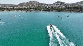 Aerial drone video from water sports in famous celebrity sandy beach of Vouliagmeni  in south Athens riviera with turquoise clear sea, Vouliagmeni, Greece