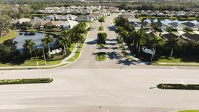 Aerial view entering a sunny suburban neighborhood in tropical climate - Powered by Shutterstock - Get 15% off with code: PIKWIZARD15