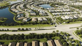 Aerial of a sunny suburban Florida neighborhood in tropical climate - Powered by Shutterstock - Get 15% off with code: PIKWIZARD15
