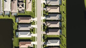 Aerial of a sunny suburban neighborhood in tropical climate looking down at homes - Powered by Shutterstock - Get 15% off with code: PIKWIZARD15