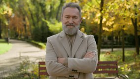 Elderly gray-haired male mature 60s man in autumn park alley outdoors old senior gentleman healthy smiling face happy portrait single pensioner crossed hands in elegant outerwear retirement in city - Powered by Shutterstock - Get 15% off with code: PIKWIZARD15