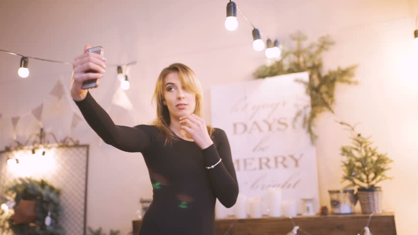 young beautiful woman in a room decorated for celebrating the new year and christmas