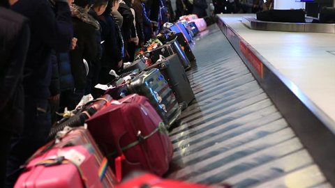 Toronto, Ontario, Canada, December 20, 2017: People pick up luggage at Toronto Pearson Airport.