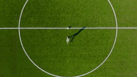 Young boy play soccer ball on the football field. Kid playing soccer on big stadium, dribbling and attacking goal. Aerial view of kid playing football in playground.  - Powered by Shutterstock - Get 15% off with code: PIKWIZARD15
