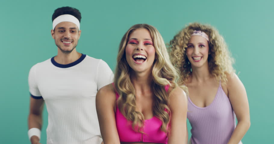 Happy, group and aerobics exercise and dance with retro fashion in studio or green background. Fitness, portrait and people moving with energy in workout for health and wellness in mock up space