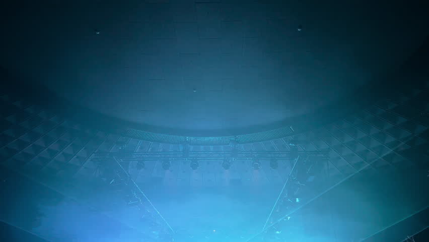 a colorful light show and a huge number of multicolored laser beams in a large indoor space