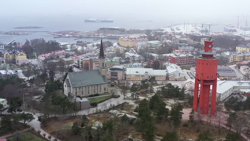 Hanko.Finland-January 3.2021: Amazing aerial shot of the water tower and the church in Hanko Finland. Port in the background. Aerial shot with the drone slowly moving sideways.