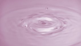 Beautiful closeup splash of pink serum drop on rose background in slow motion. Cosmetic essence serum falling in slow motion. Body moisturizing cosmetics formulating. Commercial beauty product liquid - Powered by Shutterstock - Get 15% off with code: PIKWIZARD15
