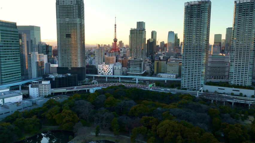 Tokyo City centre at sunset, aerial view of downtown Tokyo with modern skyscrapers, drone view of Tokyo City centre and Hamarikyu Gardens. High quality 4k footage Royalty-Free Stock Footage #3413428587