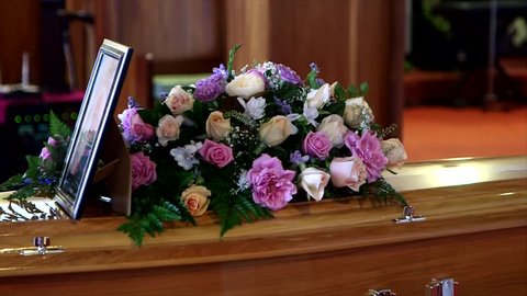 closeup shot of a colorful casket in a hearse or chapel before funeral or burial at cemetery
