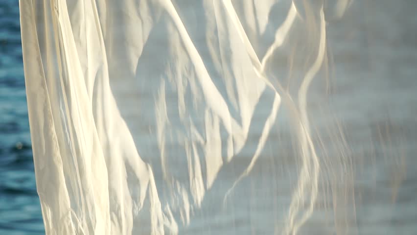 Bungalows sea sunset. Beach Lounge bed with white silky curtains. Lounge bed with canopy at seaside. Beach Chairs and Sunshades. Summer Vacation resort concept. Slow motion