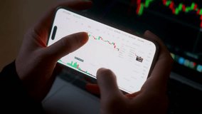 Smartphone with mobile application cryptocurrency wallet. A man analyzes the price chart for bitcoin in a mobile application. The concept of cryptocurrency trading - Powered by Shutterstock - Get 15% off with code: PIKWIZARD15