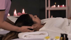 A woman enjoys a head massage, relaxing her muscles with the expertise of a professional massage therapist at a health beauty spa. - Powered by Shutterstock - Get 15% off with code: PIKWIZARD15