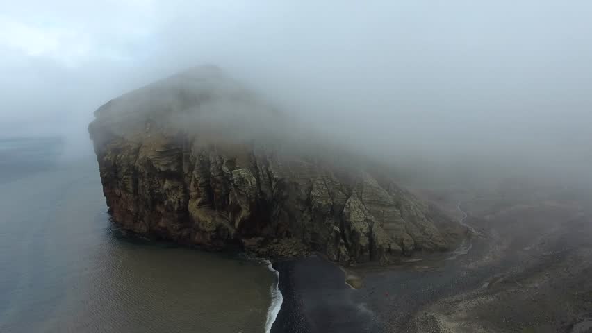 The drone rises above the rock in the fog. Andreev.
