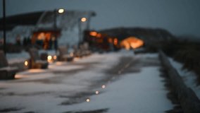 Snow drifting on the coast of North Sea with swaying marram grass, illuminated promenade with bar. Dune grass sways in the wind and snowfall on the shoreline of the North Sea on Sylt during winter. - Powered by Shutterstock - Get 15% off with code: PIKWIZARD15