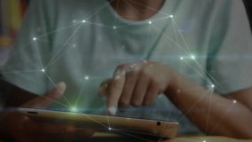 Animation of network of connections over biracial schoolboy using tablet. Technology, education and digital interface concept, digitally generated video. - Powered by Shutterstock - Get 15% off with code: PIKWIZARD15