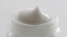 Cosmetic white cream texture closeup day night 