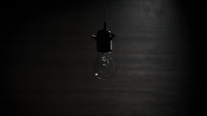 Incandescent bulb turns on, and off and flickers on black background, a place for text. Warm flashing filament close-up. Glass old bulb glowing yellow warm light. Tungsten lamp light. Idea, Copy space Royalty-Free Stock Footage #3413736923