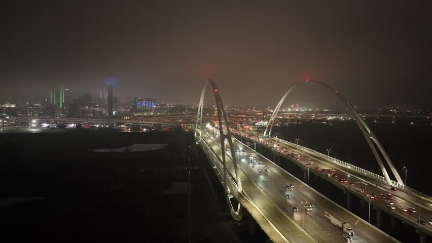 Dallas, Texas skyline at night with foggy weather and drone video stable.