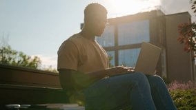African American man student guy studying outdoors with computer male study in city near university college campus pensive looking away thinking homework task online learning with laptop in sunshine - Powered by Shutterstock - Get 15% off with code: PIKWIZARD15