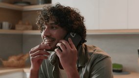 Happy smiling Indian man carefree positive talking mobile phone at home answer call friendly talk laughing smile funny casual communication discuss Arabian guy speak smartphone conversation at kitchen - Powered by Shutterstock - Get 15% off with code: PIKWIZARD15