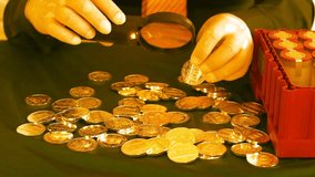 Male Banker Examines Gold Coins