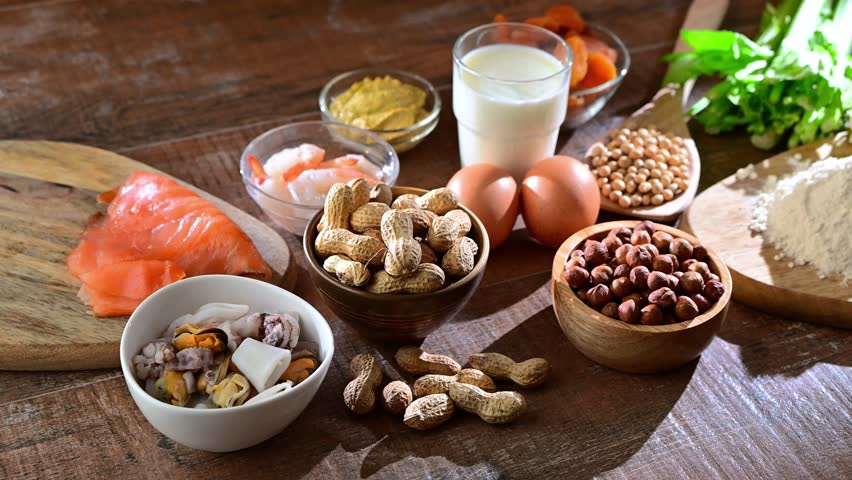 Common food allergens including egg, milk, soya, nuts, fish, seafood, wheat flour, mustard, dried apricots and celery Royalty-Free Stock Footage #3413891075