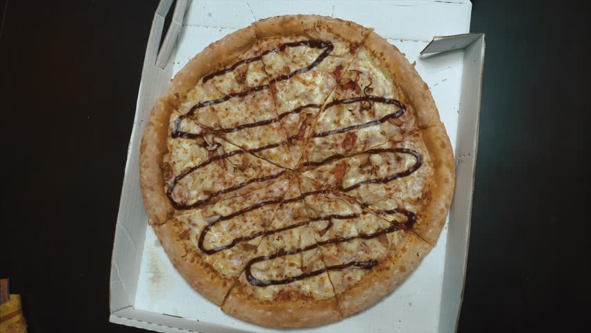 Close up of people taking slices of different pizzas. Group of multi ethnic friends eating Italian pizza take away. Friends eating pizza at home